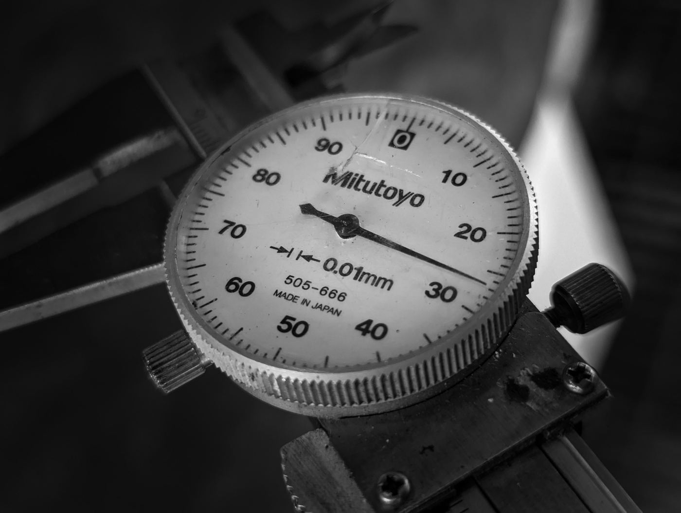 A metric dial caliper reading in 0.01mm increments